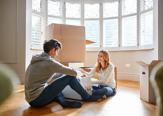 couple in empty room full of boxes