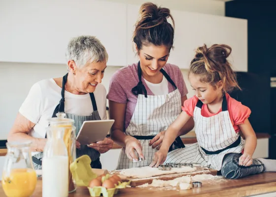 Family of grand-mother, mother and child cooking