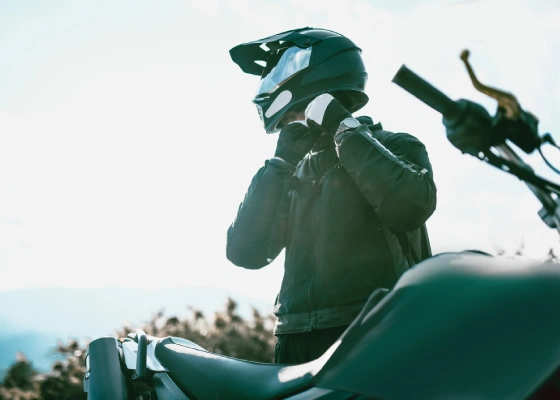 man buckling his helmet